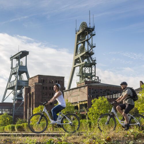 Das Foto zeigt Radfahrende an der Zeche Ewald in Herten